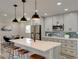 Bright kitchen featuring a marble island, pendant lighting, stainless steel appliances, and dining area at 120 Chesapeake Ave, Tampa, FL 33606
