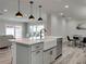 Modern kitchen with a large island, stainless steel appliances, and views into the living area at 120 Chesapeake Ave, Tampa, FL 33606