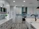 Well-appointed kitchen with gray cabinets, stainless steel appliances, and a stylish island at 120 Chesapeake Ave, Tampa, FL 33606