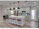 Kitchen island featuring white marble countertops, pendant lighting and seating for casual dining at 120 Chesapeake Ave, Tampa, FL 33606