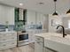 This is a modern kitchen with gray cabinets, stainless steel appliances, and stylish backsplash at 120 Chesapeake Ave, Tampa, FL 33606