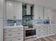 Contemporary kitchen boasts gray cabinets, stainless steel appliances, and modern tile backsplash at 120 Chesapeake Ave, Tampa, FL 33606