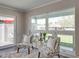 Cozy seating area with patterned chairs, a plush rug, and lots of natural light from large windows at 120 Chesapeake Ave, Tampa, FL 33606