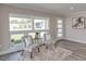 Cozy seating area with patterned chairs, a plush rug, and lots of natural light from large windows at 120 Chesapeake Ave, Tampa, FL 33606