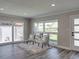 Cozy seating area with patterned chairs, a plush rug, and lots of natural light from large windows at 120 Chesapeake Ave, Tampa, FL 33606