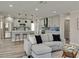 Open-concept living space featuring a modern kitchen with gray cabinets connected to the living room at 120 Chesapeake Ave, Tampa, FL 33606