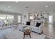 Bright, open-concept living space with modern furniture and sleek wood floors, leading into the kitchen at 120 Chesapeake Ave, Tampa, FL 33606
