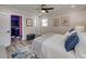 A cozy main bedroom with a ceiling fan and a blue decorative rug leading to a custom walk-in closet at 120 Chesapeake Ave, Tampa, FL 33606
