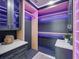 Modern walk-in closet featuring custom shelving and purple accent lighting at 120 Chesapeake Ave, Tampa, FL 33606