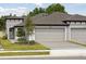 Charming single-story home featuring a two-car garage, manicured lawn, and beautiful landscaping at 12378 Oak Hill Way, Parrish, FL 34219