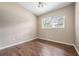 Well-lit bedroom with wood flooring and a window at 515 Hibiscus Dr, Temple Terrace, FL 33617