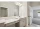 Clean bathroom with a vanity, quartz countertop, and a view of a bedroom at 12408 Oak Hill Way, Parrish, FL 34219