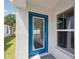 Modern blue front door with glass panel and sidelight at 12386 Oak Hill Way, Parrish, FL 34219