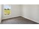 Well-lit bedroom with large window and neutral carpeting at 12378 Oak Hill Way, Parrish, FL 34219