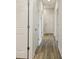 Bright hallway with wood-look flooring and neutral walls at 12378 Oak Hill Way, Parrish, FL 34219