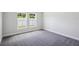 Well-lit bedroom with gray carpeting and two windows at 12378 Oak Hill Way, Parrish, FL 34219