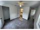 Bedroom with gray carpet, ceiling fan, and multiple doors and closets at 849 Laurelridge Ct, Brooksville, FL 34601
