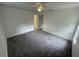 Spacious bedroom featuring gray carpet, ceiling fan, and natural light at 849 Laurelridge Ct, Brooksville, FL 34601