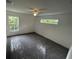 Bright bedroom with gray carpet, ceiling fan, and natural light from windows at 849 Laurelridge Ct, Brooksville, FL 34601