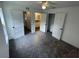 Bright bedroom with gray carpet, ceiling fan, and multiple doors and closets at 849 Laurelridge Ct, Brooksville, FL 34601