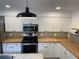 Bright kitchen with modern appliances, stylish backsplash, and butcher block countertops at 849 Laurelridge Ct, Brooksville, FL 34601