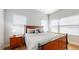 Comfortable bedroom with wood floors and large windows at 11411 Drifting Leaf Dr, Riverview, FL 33579