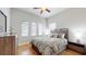 Bedroom with wood floors and a ceiling fan at 11411 Drifting Leaf Dr, Riverview, FL 33579