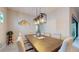 Elegant dining room featuring a large table, modern lighting, and neutral decor at 11411 Drifting Leaf Dr, Riverview, FL 33579
