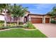 Two-story house with stone facade and three-car garage at 11411 Drifting Leaf Dr, Riverview, FL 33579