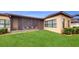 Screened patio, grassy yard, and well-manicured hedges in the backyard at 11411 Drifting Leaf Dr, Riverview, FL 33579