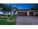 Two-story home with two-car garage and landscaped front yard at 11411 Drifting Leaf Dr, Riverview, FL 33579