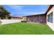 Large backyard with lush lawn and screened patio at 11411 Drifting Leaf Dr, Riverview, FL 33579