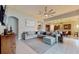 Open living room with large sectional sofa, and view into kitchen and dining area at 11411 Drifting Leaf Dr, Riverview, FL 33579