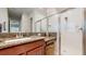 Bathroom features a walk-in shower and granite countertop at 11411 Drifting Leaf Dr, Riverview, FL 33579