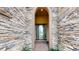Covered entryway with stone facade and arched doorway at 11411 Drifting Leaf Dr, Riverview, FL 33579