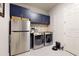 Laundry room with modern appliances and ample storage at 11411 Drifting Leaf Dr, Riverview, FL 33579