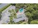 Aerial view of the community pool, parking, and lush landscaping surrounding the building at 1817 Hammocks Ave # 1817, Lutz, FL 33549