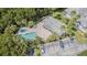 Aerial view showcasing the pool, lush greenery, clubhouse, and convenient parking area at 1817 Hammocks Ave # 1817, Lutz, FL 33549