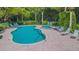 Beautiful kidney-shaped pool and hot tub with brick surround and lounge chairs for relaxing at 1817 Hammocks Ave # 1817, Lutz, FL 33549