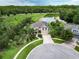 Two-story house with lake view, large yard, and circular driveway in a tranquil setting at 19300 Lonesome Pine Dr, Land O Lakes, FL 34638
