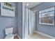 Well-lit bathroom with a shower behind a curtain and natural light from the window at 19300 Lonesome Pine Dr, Land O Lakes, FL 34638