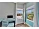 Cozy bedroom nook with a built-in desk, ample natural light and wood look tile flooring at 19300 Lonesome Pine Dr, Land O Lakes, FL 34638