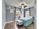 Comfortable bedroom showcases wood-look tile, a metal-framed bed, and dual windows at 19300 Lonesome Pine Dr, Land O Lakes, FL 34638