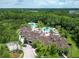 Aerial view of the stunning clubhouse and pool areas surrounded by lush landscaping and tropical trees at 19300 Lonesome Pine Dr, Land O Lakes, FL 34638