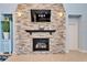 Stacked stone fireplace with a black mantel at 19300 Lonesome Pine Dr, Land O Lakes, FL 34638