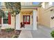 Covered entrance with red double door, white columns and a bench, next to manicured landscaping at 19300 Lonesome Pine Dr, Land O Lakes, FL 34638