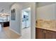 A connecting hallway leading to the modern laundry room at 19300 Lonesome Pine Dr, Land O Lakes, FL 34638