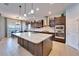 Modern kitchen with stainless steel appliances, large island, and sleek dark wood cabinetry at 19300 Lonesome Pine Dr, Land O Lakes, FL 34638