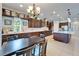 Bright kitchen featuring a large island, dark cabinetry, stainless steel appliances, and dining area at 19300 Lonesome Pine Dr, Land O Lakes, FL 34638