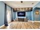 A stylish living room with a large TV, custom cabinetry, and access to the outdoors at 19300 Lonesome Pine Dr, Land O Lakes, FL 34638